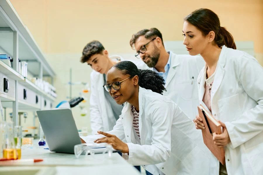 Researchers checking a computer in a lab